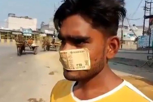 Man-wears-note as a mask